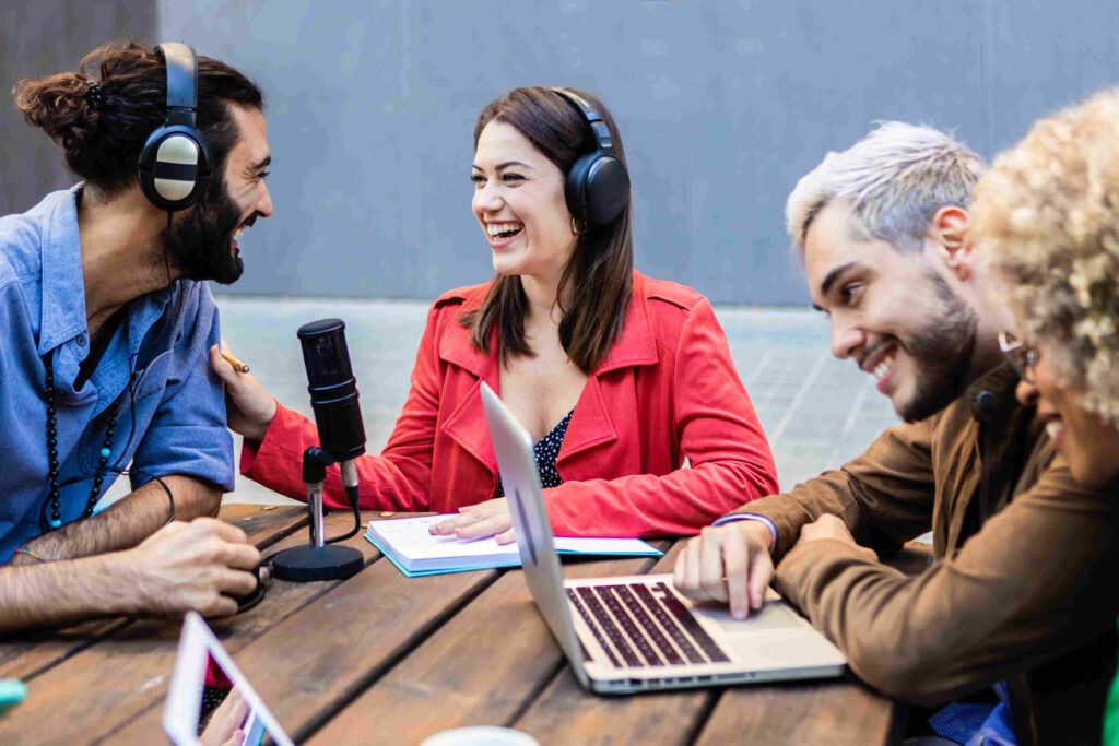A diverse group of podcasters in casual attire, engaging in a vibrant discussion around a microphone, exemplifying the collaborative process of character development in podcast storytelling